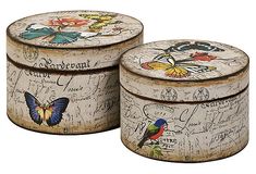 two round tins with butterflies and writing on the lids, one has a butterfly painted on it