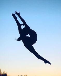 a silhouette of a person jumping in the air