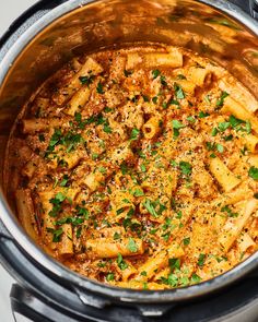 pasta in a slow cooker with parsley on top