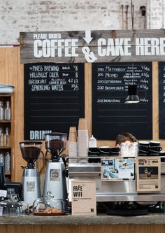 there is a coffee shop with menus on the wall