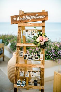 a wooden ladder with pictures and flowers on it