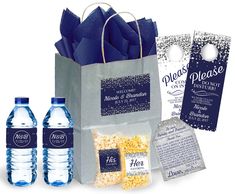 three bottles of water and two bags of popcorn with tags attached to the bag,