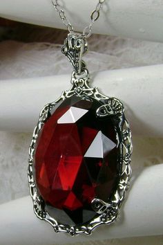 "Red Garnet Cubic Zirconia Pendant Bubble Design#P10 Custom Made Inspired by Victorian era designs, I now offer this lovely Antique reproduction in sterling silver. The flawless 22ct faceted Red Garnet Cubic Zirconia (CZ) is 24mm long (15/16th\") and 18mm in width (3/4th\"). The entire pendant is 1 1/2th inches long and 7/8\" wide. The chain (if chosen) is between 18-20 inches in length and is marked 925 as well. Notice the beautiful craftsmanship of the Victorian filigree setting. This pendant Red Ruby Jewelry With Intricate Design, Luxury Red Ruby Jewelry With Intricate Design, Exquisite Red Jewelry For Gift, Antique Jeweled Red Jewelry, Red Victorian Jewelry For Evening, Red Gothic Jewelry For Party, Gothic Round Ruby Jewelry, Red Oval Victorian Necklace, Gothic Red Gemstone Jewelry