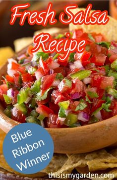 a wooden bowl filled with salsa and tortilla chips on top of a table