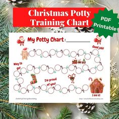 christmas potty training chart is shown on top of a table with pine cones and ornaments