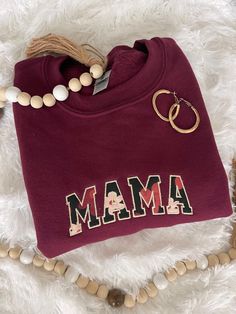 Surprise your mama or loved ones with this floral and cute embroidered sweatshirt featuring a MAMA applique design. Perfect for Mother's Day gift or birthdays coming up! MAMAs deserve a cozy and super comfy sweatshirt to lounge in or run errands in. Trendy sweatshirt color options available, including Maroon, Sand, Heather Green, and Light Blue. If there is a color you have in mind other than the ones available, send me a message and I can help! -Sweatshirt brand: Gildan -Sizes available: Adult Red Embroidered Sweatshirt For Fall, Casual Sweatshirt With Custom Embroidery For Mother's Day, Red Letter Embroidery Sweatshirt For Fall, Custom Embroidery Sweatshirt As Fall Gift, Fall Custom Embroidery Sweatshirt Gift, Red Embroidered Text Sweatshirt For Fall, Casual Mother's Day Sweatshirt With Embroidered Graphics, Casual Embroidered Sweatshirt For Mother's Day, Fall Gift Sweatshirt With Embroidered Graphics