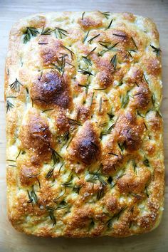 a square loaf of bread with herbs on top