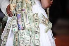 a woman in a white dress with money tied to her waist