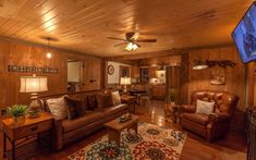 a living room filled with furniture and a flat screen tv mounted to the side of a wall