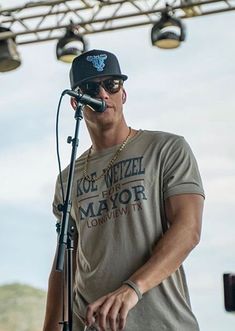 a man standing next to a microphone on top of a stage