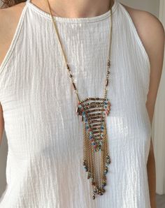 This Handmade Ethnic Necklace is a very unique beaded jewelry, which is going to be yours if you are here.  Its ethnicity and elegance comes from the traditional tribal ethnic design and boho minimalist string structure. It is designed and produced by local shaman artisans. Shamanism is known as a nature worship belief. Shamans bound their soul with nature. Our necklace is designed and is became alive with this bound. If you would like a distinctive, unique, ethnic and dainty necklace, Zoho Acce Bohemian Long Necklace With Tassels, Adjustable Bohemian Long Necklace With Tassels, Multicolor Bohemian Metal Beads Jewelry, Bohemian Beaded Necklaces With Tassels, Dangle Tassel Necklace For Festivals, Festival Multi-strand Beaded Chain Long Necklace, Bohemian Tassel Necklace With Beaded Chain, Spiritual Beaded Long Tassel Necklace, Bohemian Beaded Chain Long Necklace