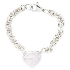 Add a touch of iconic elegance to your jewelry collection with this Tiffany & Co Heart Chain Bracelet. Crafted from high-quality sterling silver, this bracelet features delicate heart-shaped links that showcase Tiffany's timeless design aesthetic. With its classic appeal and designer pedigree, this bracelet is the perfect accessory for any occasion, offering both style and sophistication. Length: 7 in. Width: 7.9 mm Heart Length: 3/4 in. Weight: 17.6 dwts. / 27.4 grams Stamps: "925 Tiffany and Co." Layaway: * We offer a very flexible layaway plan! We ask for a 20% non-refundable deposit and then 2-8 equal payments after that. Please contact us for more information! A Couple Of Things to Note: * This is a vintage item and may show signs of wear. It has been cleaned. * Please feel free to re Tiffany Charm Bracelets, Heart Chain Bracelet, Pandora Bracelet Charms Ideas, Pandora Bracelet Charms, Heart Chain, Bracelet Sterling Silver, Tiffany And Co, Design Aesthetic, Pandora Bracelet