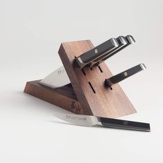 a knife holder with three knives on it