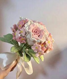 a person holding a bouquet of flowers in their hand