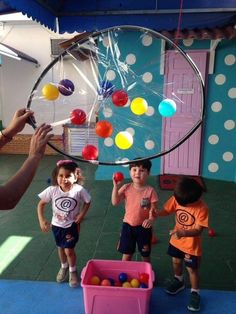 children are playing with balls in an indoor play area