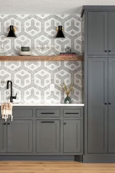 an image of a kitchen setting with grey cabinets and white wallpaper on the walls