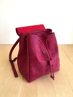 "This bag is made of high quality vegan leather in red. It is very soft and lightweight but durable. It has a rustic, distressed look. It has one interior and one exterior zipper pocket. Straps are adjustable. It is suitable for both men and women. There is two size option: Small : 17 x 27 x 30 cm Large : 20 x 30 x 36 cm IMPORTANT! Your orders between 7-25 August will be shipped on August 28. Delivery takes 2-5 days to the US, Canada, Australia and Europe; in 3-7 days to rest of the world after Red Leather Backpack With Adjustable Strap For On-the-go, Functional Red Leather Bag, Everyday Burgundy Backpack, Red Rectangular Leather Backpack For Everyday, Rectangular Red Leather Backpack For Everyday, Leather Backpack With Adjustable Strap In Burgundy, Burgundy Backpack With Adjustable Strap For Daily Use, Modern Red Backpack For Daily Use, Everyday Red Leather Backpack With Adjustable Strap