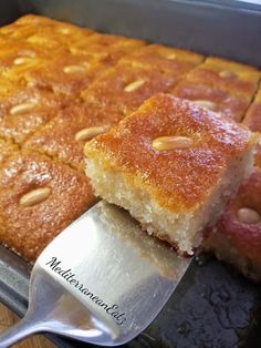 a close up of a cake on a pan with a spatula