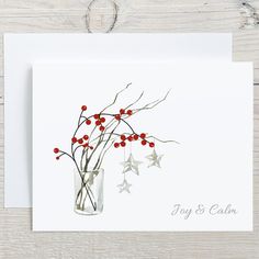 a white card with red berries in a vase and stars on the bottom reads, joy & calm