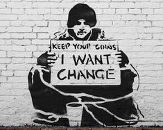 graffiti on the side of a brick wall depicting a man holding a sign that says keep your coins i want change