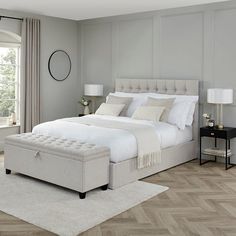 a bedroom with a large bed and two nightstands on either side of the bed