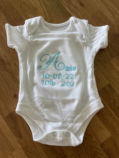 White 0-3 months short sleeved  baby  grow embroidered with name, date and weight of the new arrival can be made in a selection of different colours.  Perfect gift idea for a new arrival  All handmade to order usually takes 2/3 days to create White Short Sleeve Onesie For Baptism, Cotton Baptism Onesie With Short Sleeves, White Short Sleeve Onesie For First Birthday, White Personalized Short Sleeve Onesie, Personalized Short Sleeve Onesie For Gift, Personalized Short Sleeve Onesie As Gift, White Short Sleeve Bodysuit For Birthday, White Short Sleeve Bodysuit As A Gift, White Short Sleeve Bodysuit As Gift