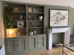 a living room filled with furniture and a fire place under a painting on the wall