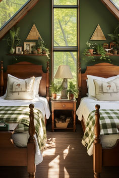 two beds in a room with green walls and wooden headboards, one has a checkered blanket on it