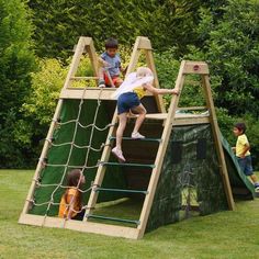 two children playing on a wooden play set