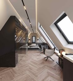 an attic bedroom with wood floors and skylights