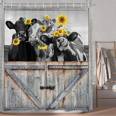 three cows with sunflowers on the barn door