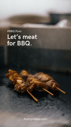 some meat is being cooked on the grill with chopsticks in front of it