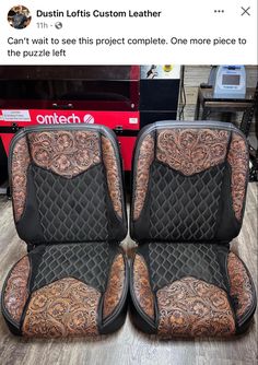 two black and brown leather seats sitting on top of a wooden floor next to each other