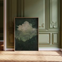 an empty room with green walls and a painting on the floor in front of it