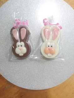 two bunny and rabbit shaped chocolate candies in cellophane bags on a table