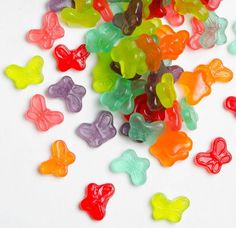 a pile of gummy bears sitting on top of a white table