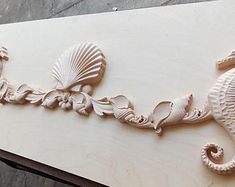 the word seahorse is carved into wood