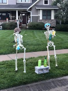 two skeleton statues in front of a house