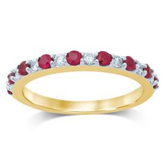 a yellow gold ring with red and white stones