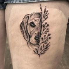 a black and white photo of a dog on the thigh