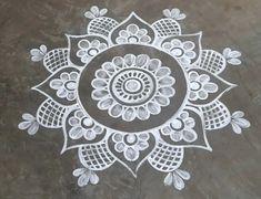 an intricate design on the ground with white paint