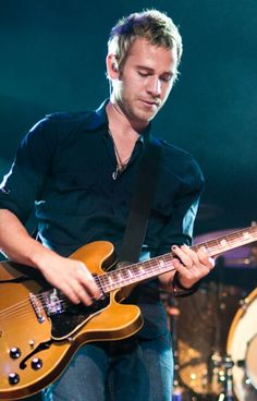 a man playing an electric guitar on stage