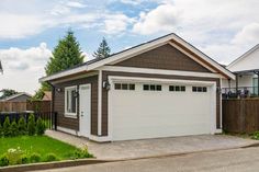 a house with two garages in front of it