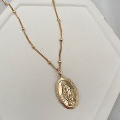 This stunning necklace is a powerful reminder of faith. Often worn to remind us of the power of trusting in prayer. Let our Mother Mary Miraculous Medal necklace be a reminder that you are held in loving protection. A powerful symbol of faith, wear it as a reminder to be open to receive its graces. Medal measure 12x21mm. 14kt gold fill or sterling medal measures 12x21mm 14kt gold fill or sterling silver satellite chain. Open To Receive, Miraculous Medal Necklace, Miraculous Medal, Mother Mary, Stunning Necklace, Our Lady, 14kt Gold, Xmas Gifts, Metal Chain