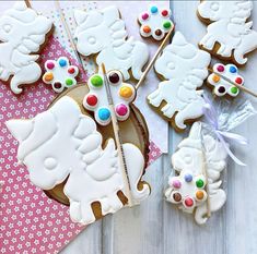 hello kitty decorated cookies and candy sticks on a table