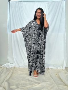 Indulge in the beauty of our classic kaftan with hand silk-screen printed fabric. This kaftan dress boasts unique patterns on high-quality rayon fabric. Its versatile design allows you to create many stylish looks, ensuring you always feel your best, whether you're at home or stepping out. Black Printed Rayon Dresses, Black Printed V-neck Kaftan, Flowy Rayon Kaftan For Beachwear, Traditional Black Printed Kaftan, Floral Print Long Kaftan In Free Size, Long Floral Print Patterned Kaftan, Long Patterned Kaftan With Floral Print, Floral Print Long Kaftan Free Size, Black Printed One Size Dress