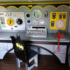 a batman themed desk and chair in a playroom