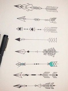 a pen and some arrows on top of a piece of paper