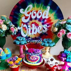 a table topped with lots of cakes and cupcakes