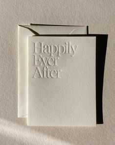 two white cards with the words happily ever after printed on them, sitting next to each other